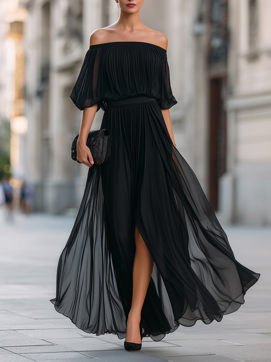Vorderansicht einer eleganten Dame im schwarzen Off-Shoulder Plissee Maxikleid auf der Straße