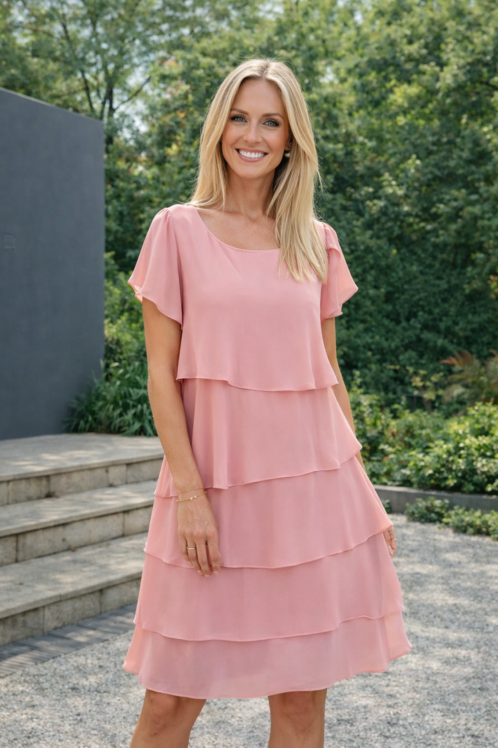 Damen in einem rosa Rüschenkleid mit lockerer Passform