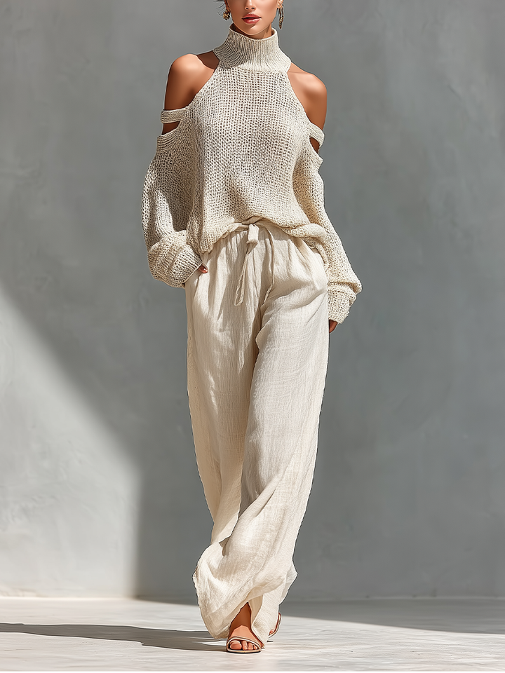 Damen Strick-Off-Shoulder-Top und weite Hosen in Beige vor grauem Hintergrund