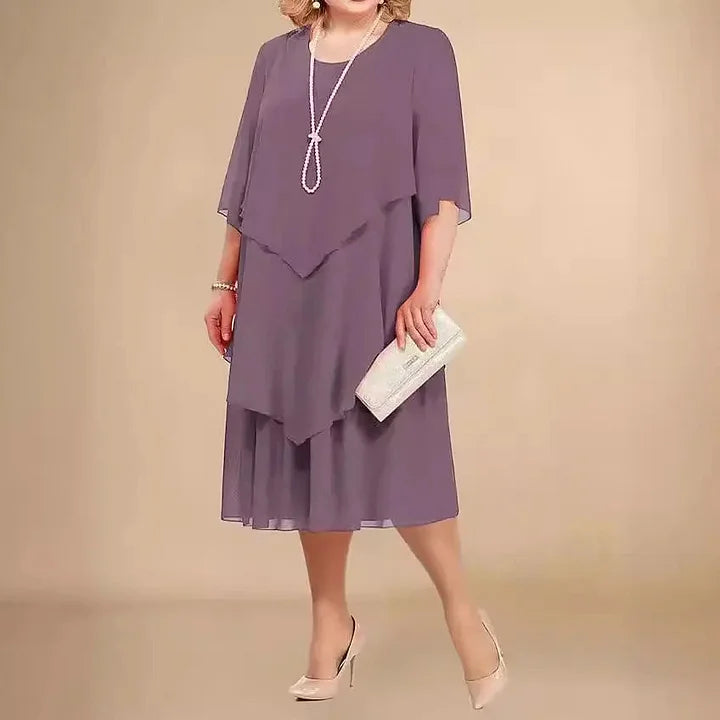 Detaillierte Ansicht des asymmetrischen Saums bei dem eleganten Midikleid für Damen.