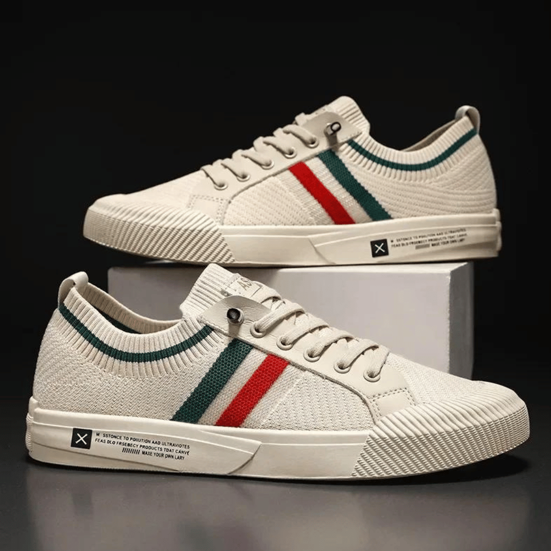 Zwei Paar beige Herren Sneaker auf einer weißen Box gestapelt