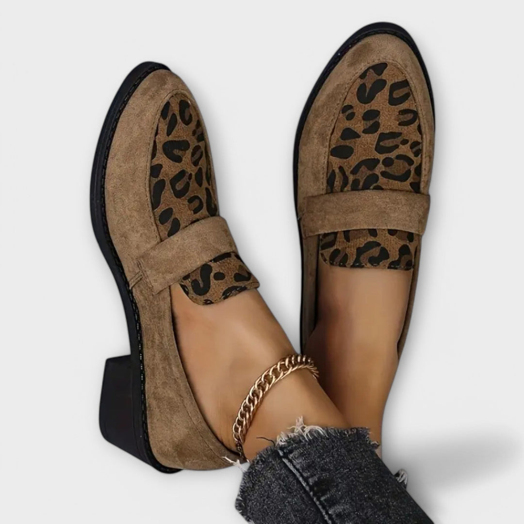 Nahaufnahme eleganter Damen Loafer mit Leopardenmuster an Füßen