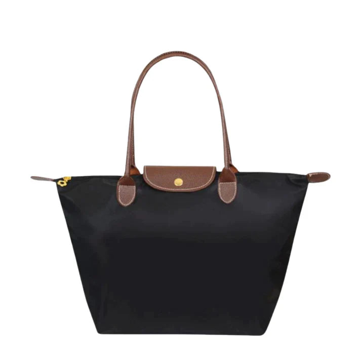 Celeste Damen Handtasche in Schwarz mit braunen Ledergriffen, elegant und vielseitig.