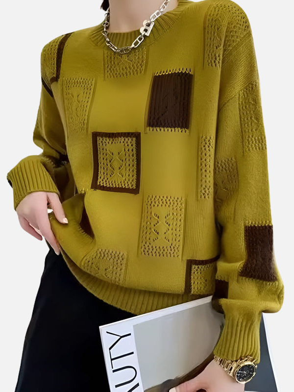 Nahaufnahme des gelben Strickpullovers mit feinem Lochmuster und Rippbündchen