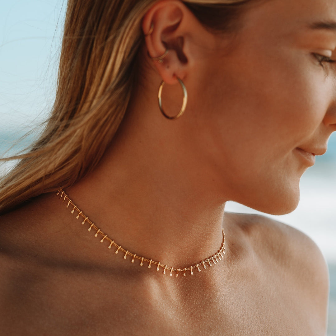 Elegante goldene Choker Halskette am Hals einer Frau