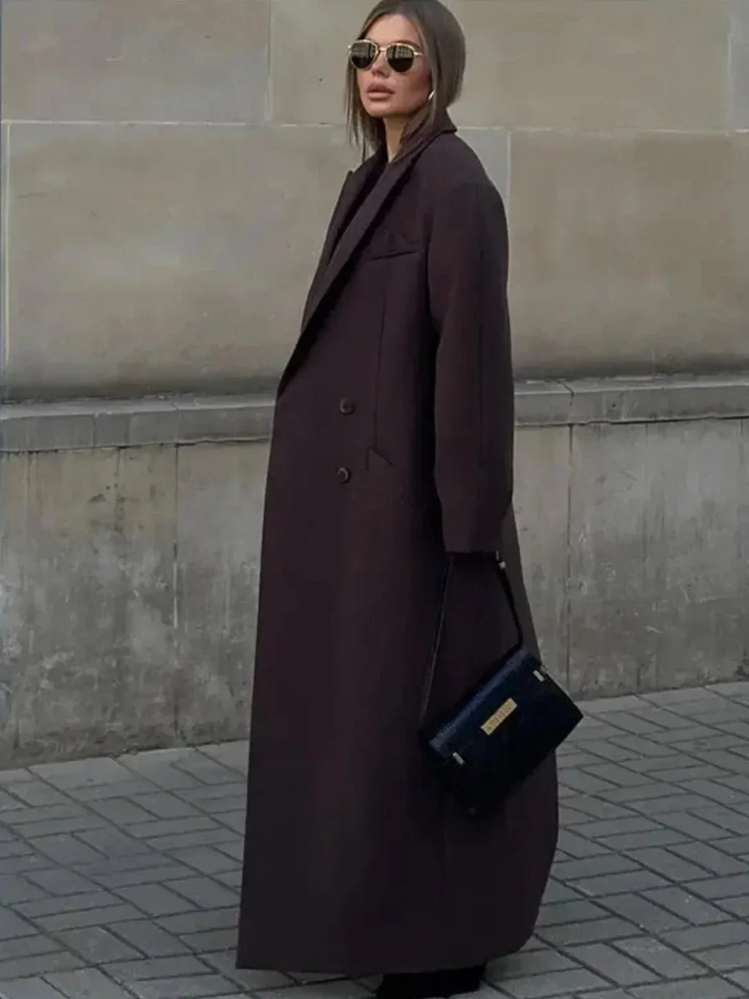 Rückansicht: Langer, übergroßer Damen Trenchcoat in Braun. Doppelreihiger, klassischer Wintermantel.