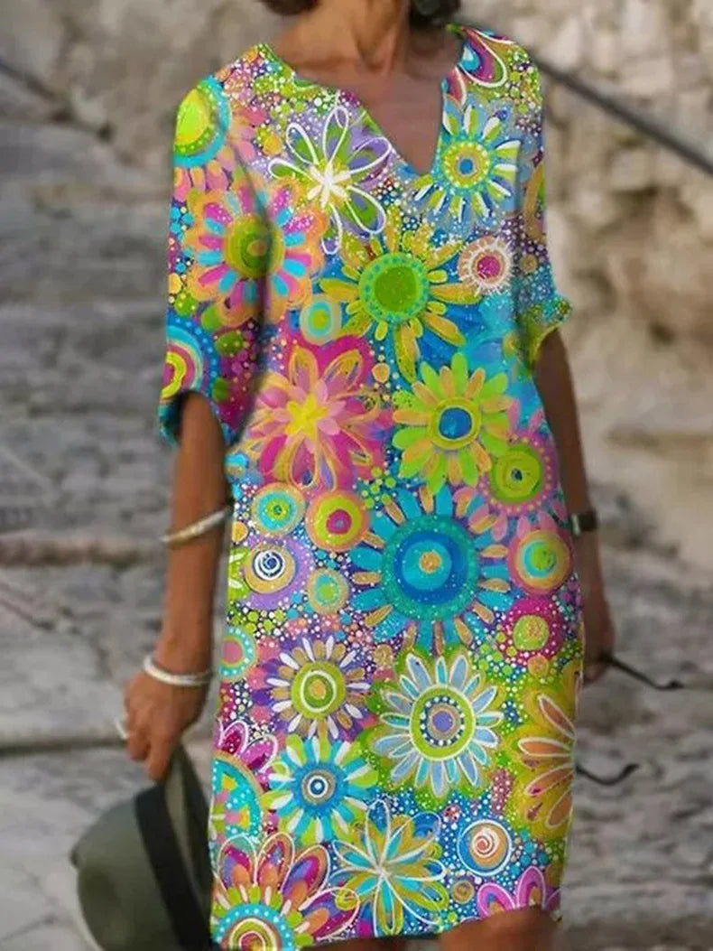 Elegantes Damen Shiftkleid mit V-Ausschnitt und langen Ärmeln, florales Muster in Grün, Gelb, Rosa.