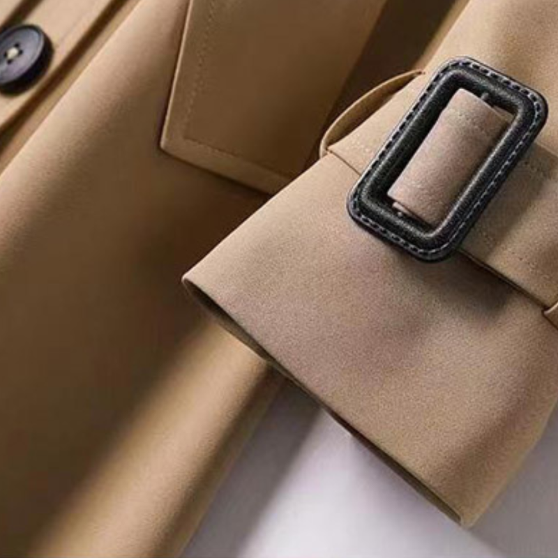 Warmer Trenchcoat für Damen in Grau, mit modernem Schnitt und Gürtel.