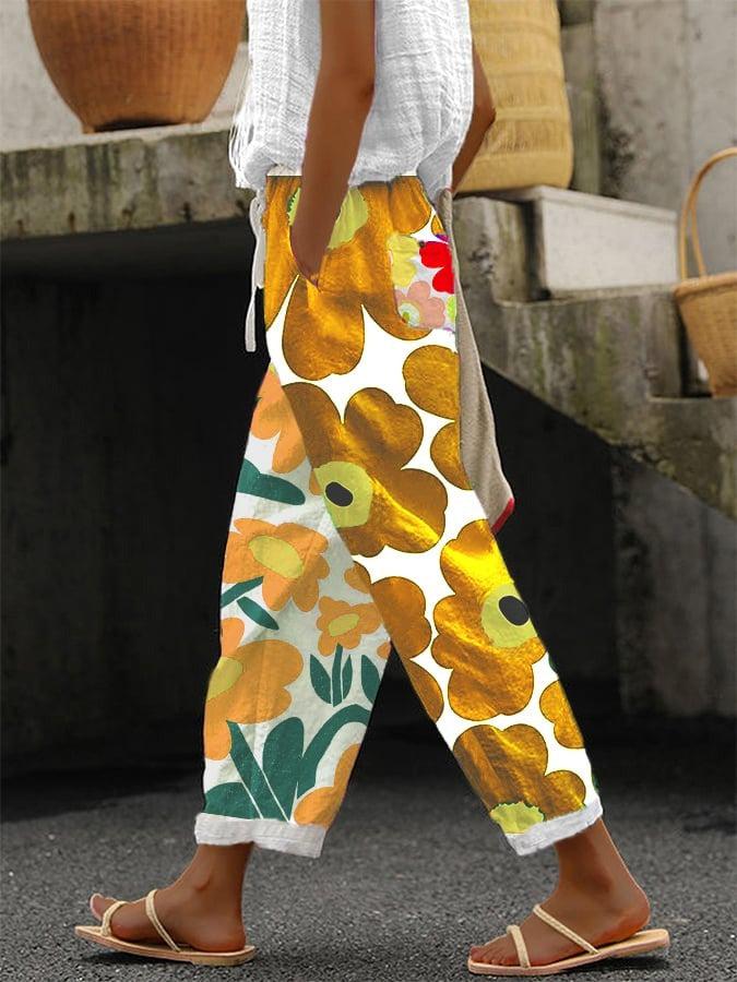 Stilvolle gelbe Damenhose mit auffälligem Blumenprint. Komfortable Freizeithose für einen frischen, eleganten Look.