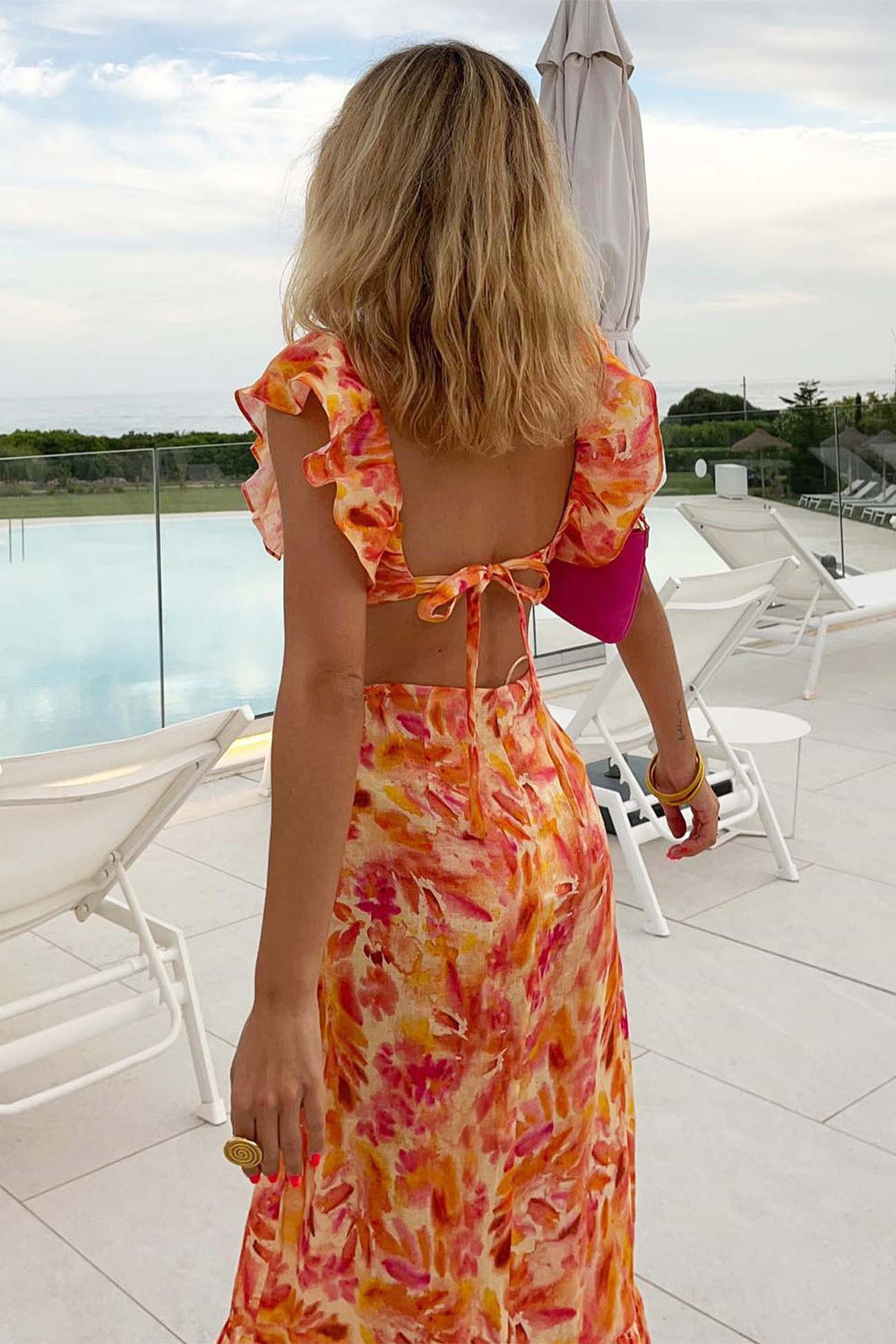 Stilvolles langes Damenkleid mit floralem Muster und Rüschensaum, perfekt für Freizeit oder Abend.