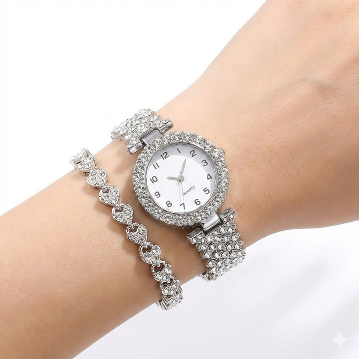 Damen Uhr mit funkelnden Glitzersteinen am Zifferblatt und dazu passendem filigranen Herzarmband, ein schimmerndes Set.