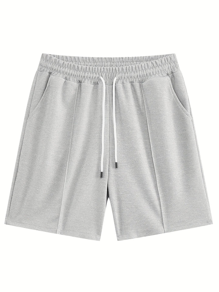 Herren Sportset im Waffelstrick Stil, dynamische Pose beim Workout im Freien
