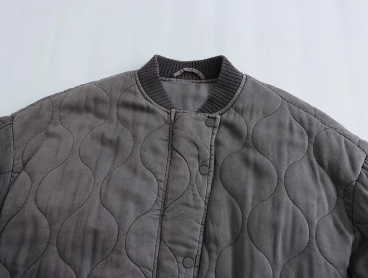 Stylische graue Steppjacke für Damen. Lockerer Schnitt und modernes Design machen sie zur perfekten Übergangsjacke.