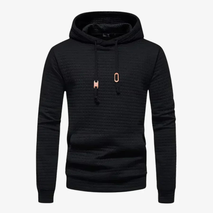 Junger Mann trägt trendigen Karomuster Hoodie. Bequemer Herren Kapuzenpullover für Freizeit und urbanen Lifestyle.