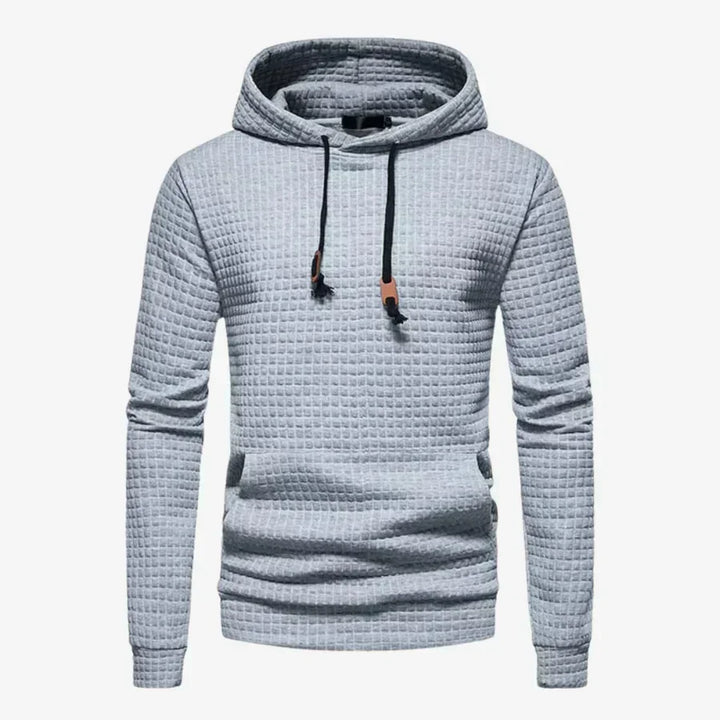 Detailaufnahme: Weicher Herren Karomuster Hoodie. Stilvoller Kapuzenpullover mit klassischem Design für Männer.