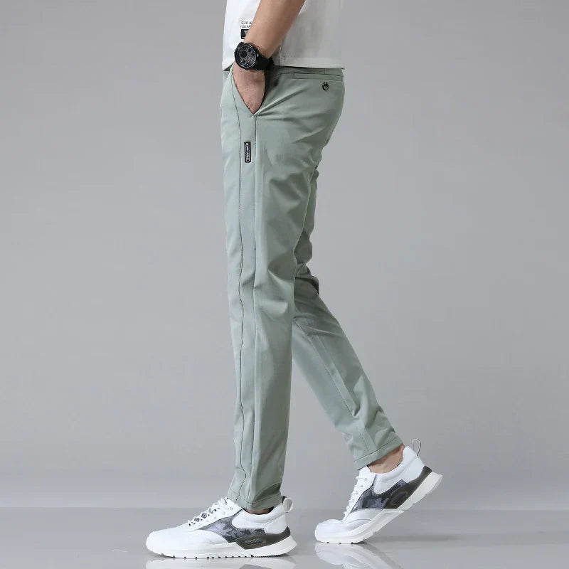 Mann trägt moderne Herren Slim Fit Stretchhose in Dunkelblau, kombiniert mit Business Hemd.