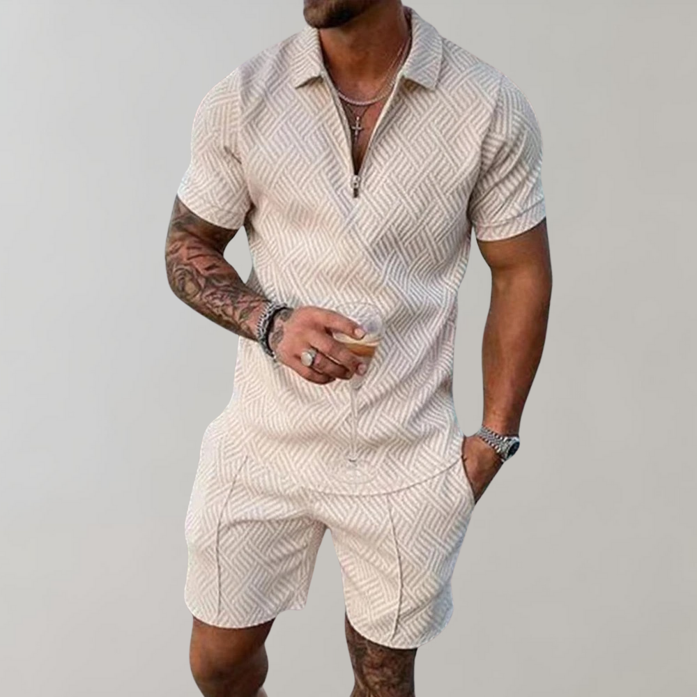 Mann trägt ein leichtes Herren-Sommer-Set mit Poloshirt und Shorts am Strand, bereit für den Urlaub.