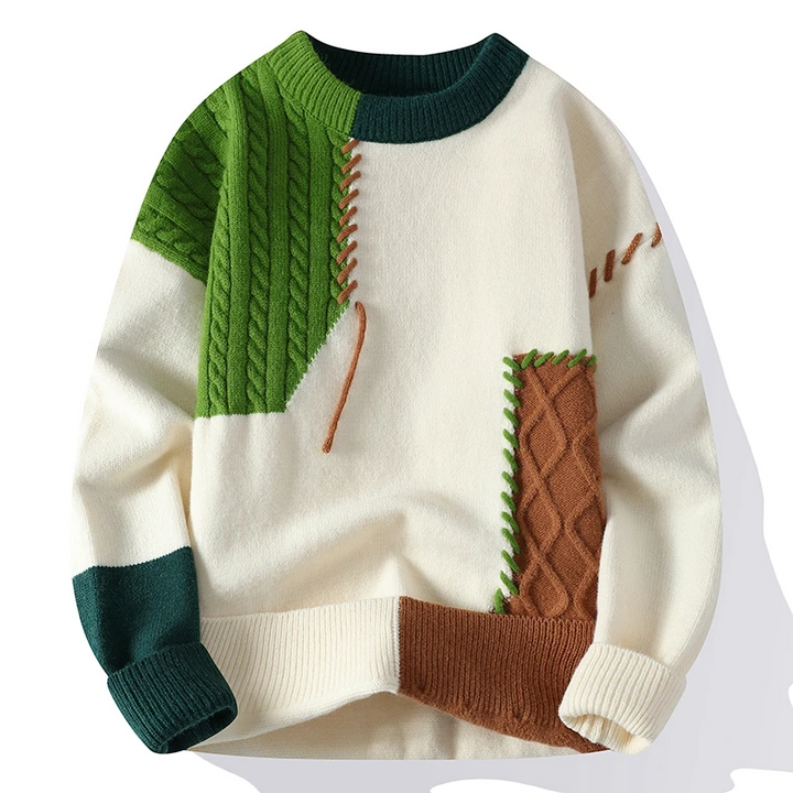 Detailansicht Herren Strickpullover: Zopfmuster, Zierstich-Details & Patchwork in Elfenbein, Grün, Dunkelblau.