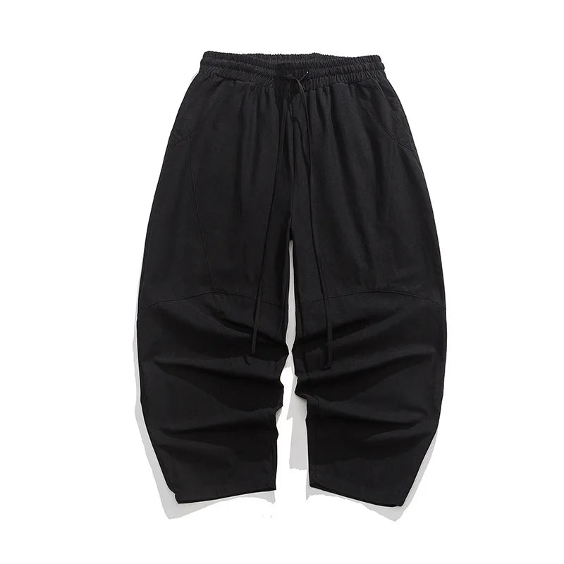 Elegante Herren-Weithose in Grau mit lockerem Schnitt, Elastikbund und stilvollen Ziernähten. Perfekt als Freizeithose.