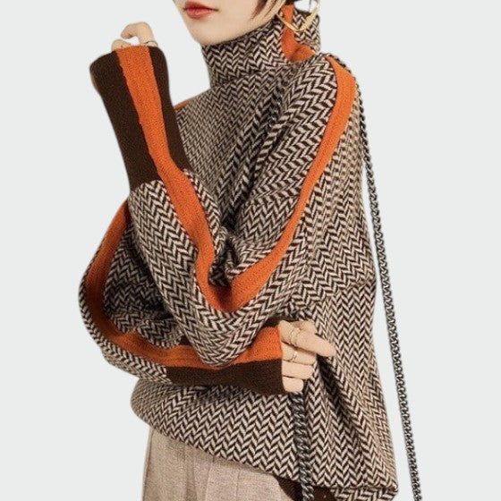 Damen Rollkragenpullover mit Zickzack-Muster und orangefarbenen Streifen an den Ärmeln.