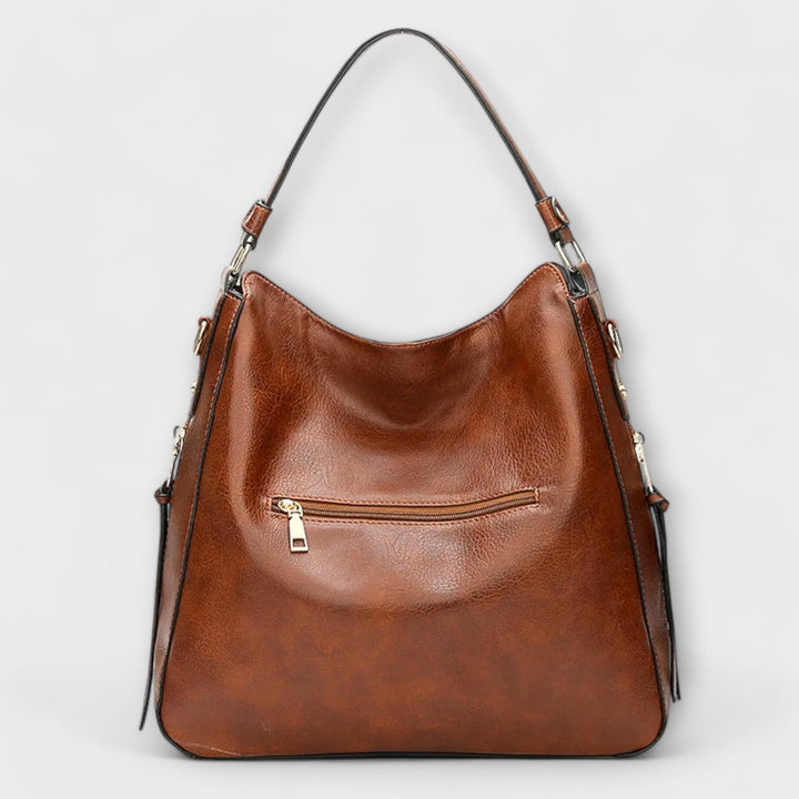 Modische Damen-Schultertasche in Schwarz, glattes Material, als vielseitige Alltagstasche tragbar.