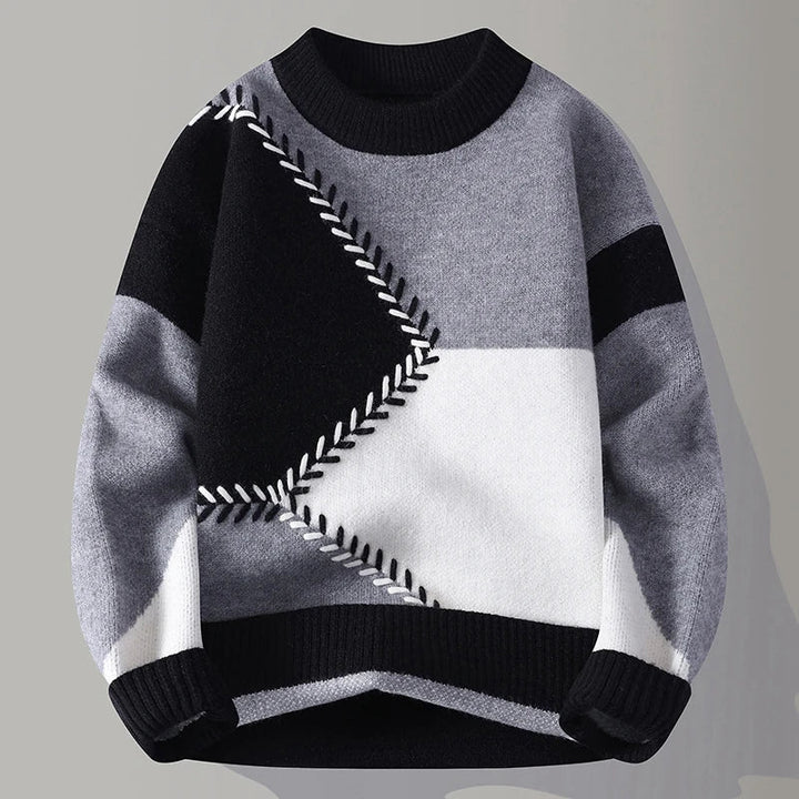Detailaufnahme des Herren Color-Blocking Pullovers mit strukturiertem Strickmuster in modernen Farbtönen. Wintermode.