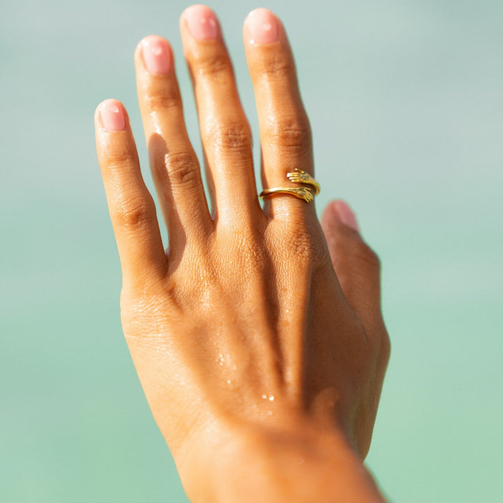 Verstellbarer Ring aus goldfarbenem Metall als elegantes Accessoire präsentiert